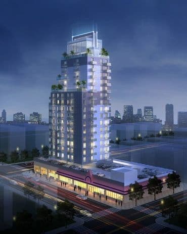 Illuminated high-rise with rooftop greenery at night in Queens